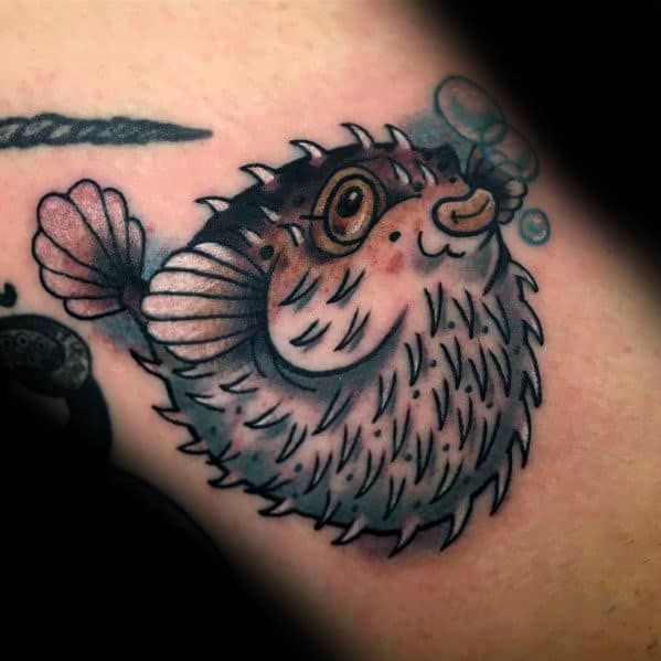 Whimsical pufferfish tattoo with soft shading, playful expression, and bubble details, creating a lively and dynamic underwater look.