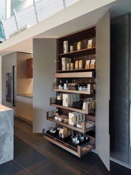 Modern pantry with pull-out wooden shelves and neatly organized items.