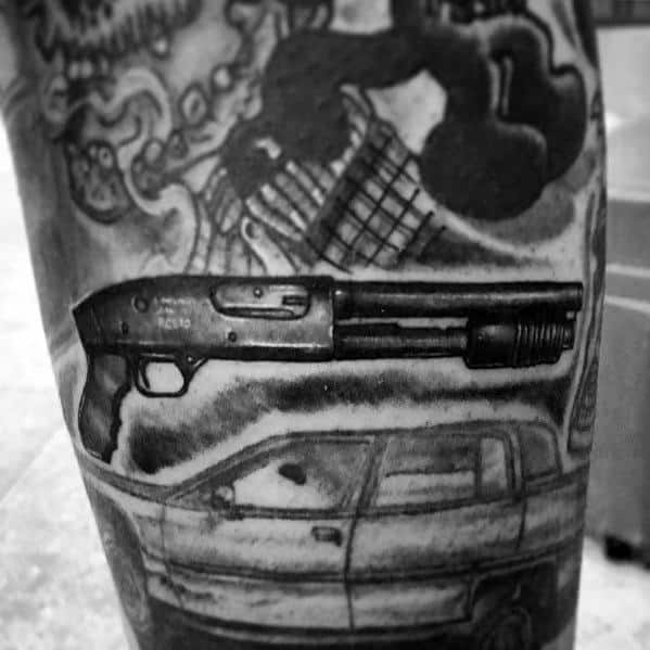 Black and grey tattoo featuring a detailed pump-action shotgun, a car, and dramatic shading, creating a bold and intense design.