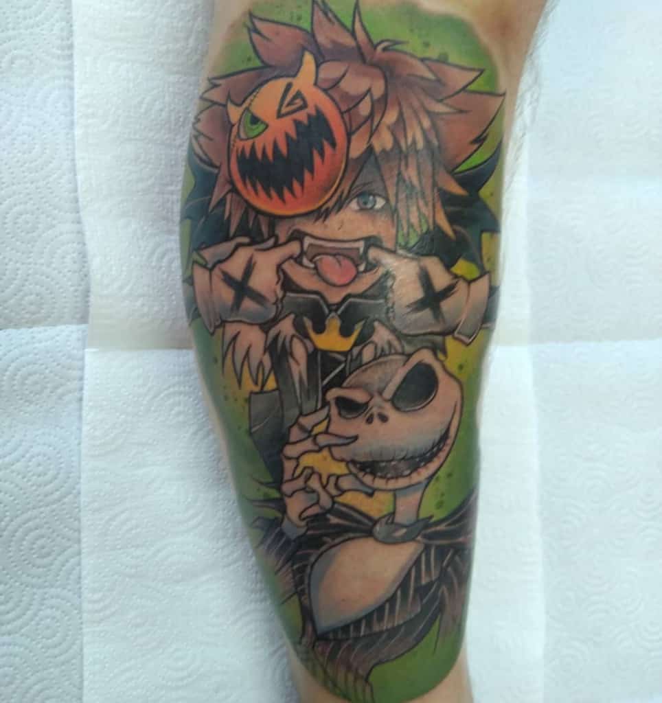 Colorful Kingdom Hearts tattoo featuring Halloween Town Sora with a pumpkin mask and Jack Skellington, set against a spooky green background.