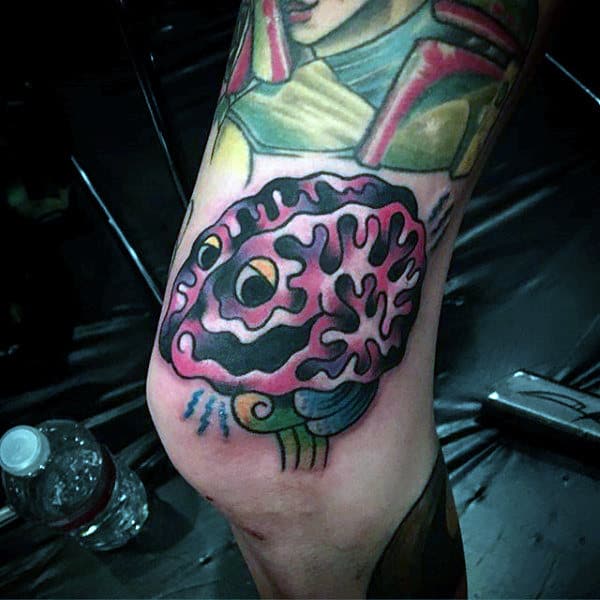 Purple Brain With Yellow Eye Guys Thigh Tattoo