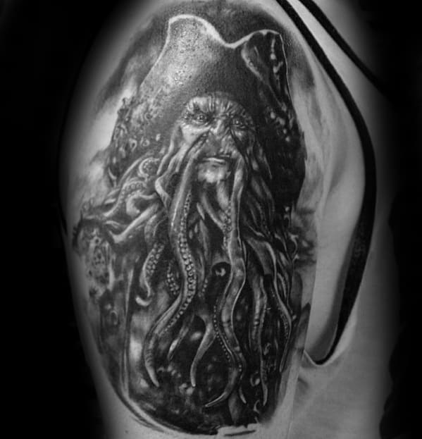 Black and white tattoo of a Davy Jones-style pirate with an octopus head on upper arm