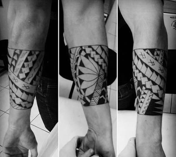 Close-up of a forearm tattoo featuring bold, geometric, black and white patterns