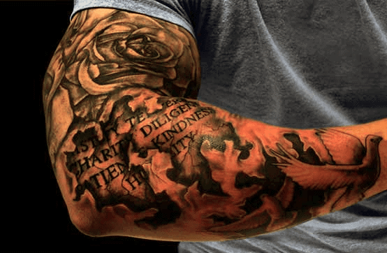 Arm tattoo with rose, dove, and words like "Diligence" and "Kindness" on an arm