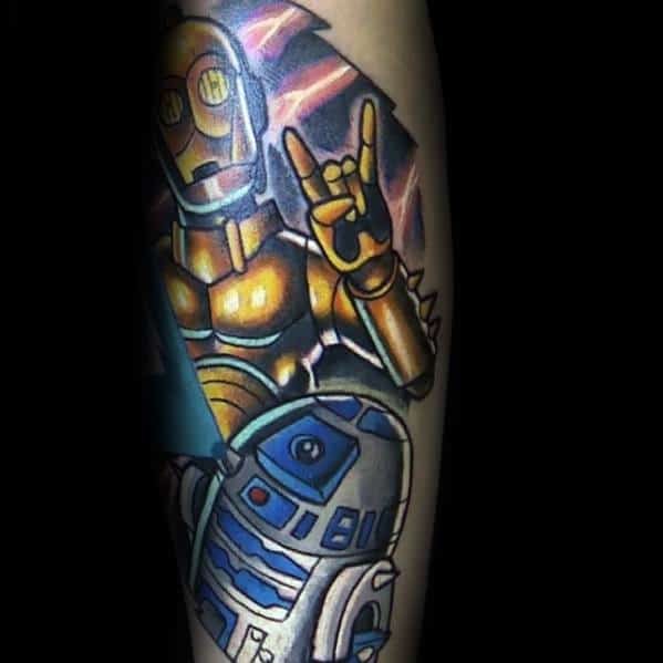 Rockstar-style C-3PO and R2-D2 tattoo featuring bold colors, lightning bolts, and a "rock on" hand gesture, blending sci-fi with punk energy.