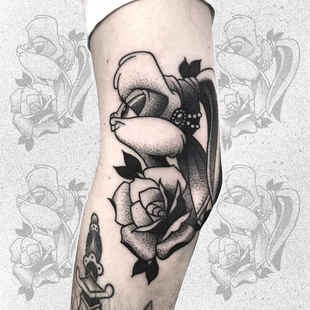 Black and grey tattoo of a veiled skull with a pearl headpiece and a detailed rose, featuring bold shading on the arm.