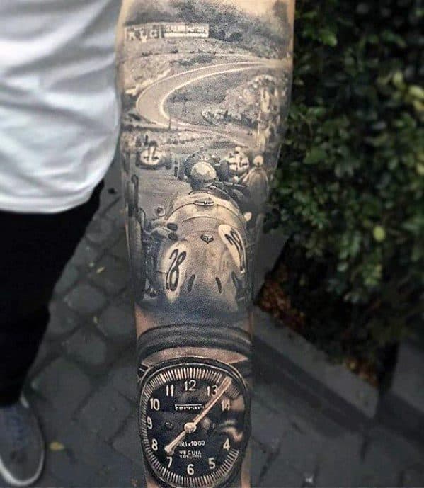 Detailed tattoo sleeve featuring a vintage race car, winding track, and Ferrari speedometer in black and grey realism style.