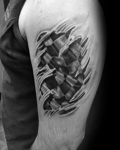 Realistic torn-skin checkered flag tattoo on the upper arm, creating a 3D effect as if the flag is beneath the skin, symbolizing racing passion.