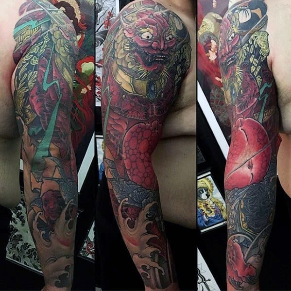 Dark Raijin full sleeve tattoo with intense red thunder god, glowing eyes, green lightning, and dramatic shading in Japanese style.