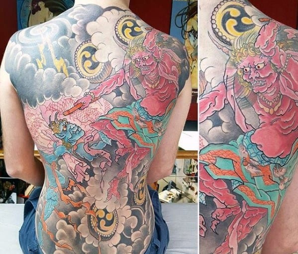 Colorful Raijin full back tattoo with two thunder gods in motion, swirling clouds, lightning bolts, and bold Japanese drum symbols.