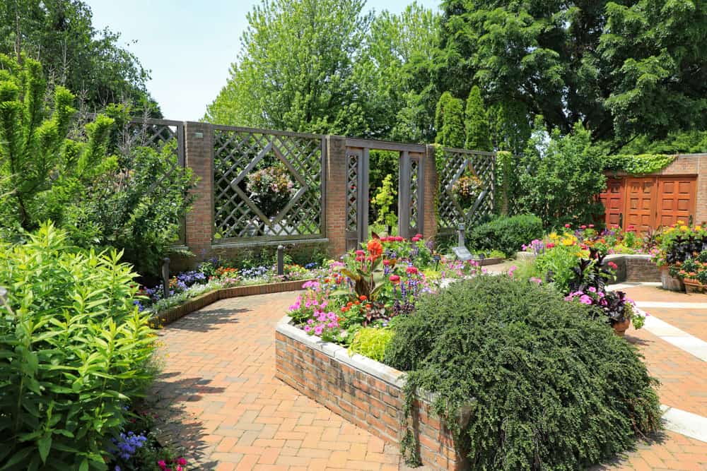 raised bed flower garden brick paver path