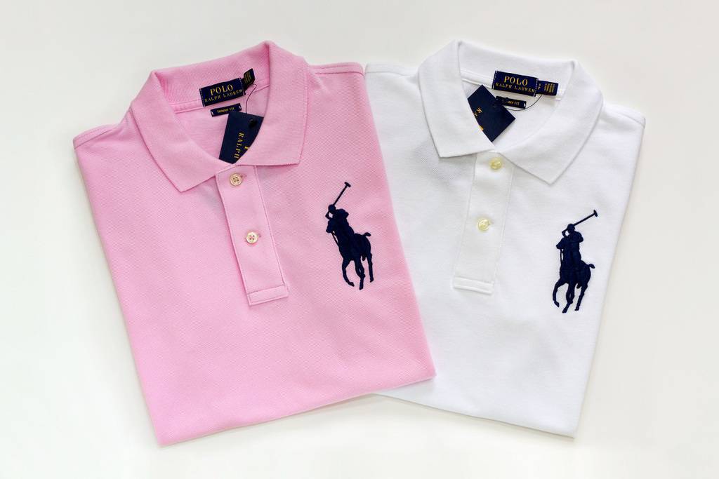 A pink Ralph Lauren polo and a white Ralph Lauren polo on a white background