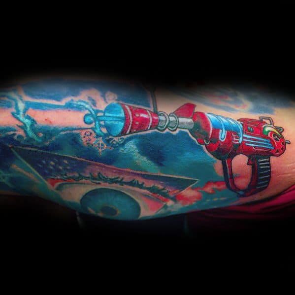 Vibrant Call of Duty Ray Gun tattoo featuring bright red and blue tones, with an energy blast effect for a dynamic and futuristic design.