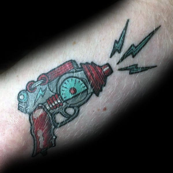 Futuristic ray gun tattoo with a steampunk-inspired design, featuring bold red and teal tones, mechanical details, and electric energy bursts.