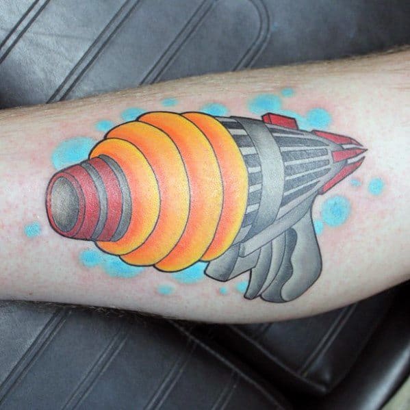 Futuristic ray gun tattoo with a bold sci-fi design, featuring glowing orange energy rings, metallic shading, and a sleek, retro-inspired look.