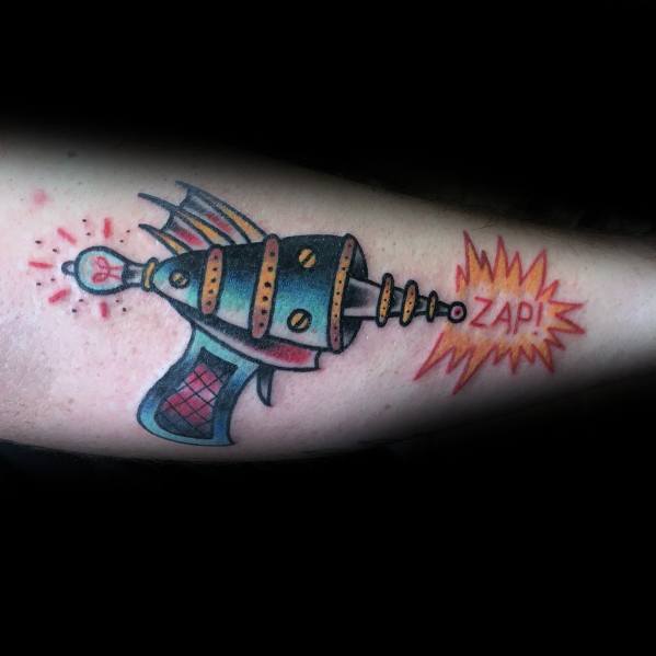 Retro sci-fi ray gun tattoo with bold colors, intricate details, and a comic-style "ZAP!" effect for a dynamic and playful look.
