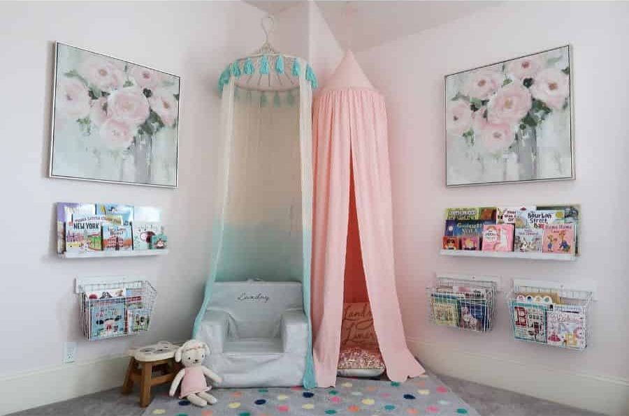 pastel reading nook in kids playroom with floral artwork