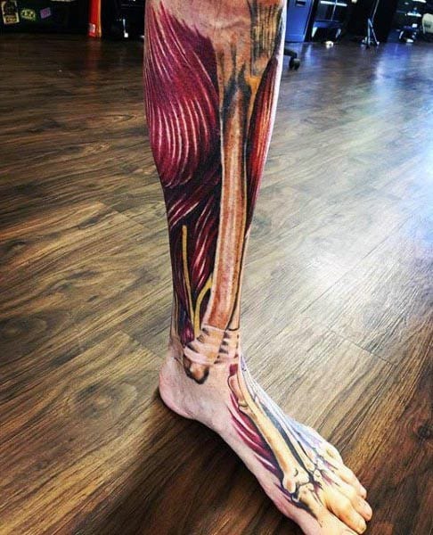 Full leg tattoo featuring hyper-realistic exposed muscles, tendons, and bones from thigh to foot, mimicking anatomical dissection.