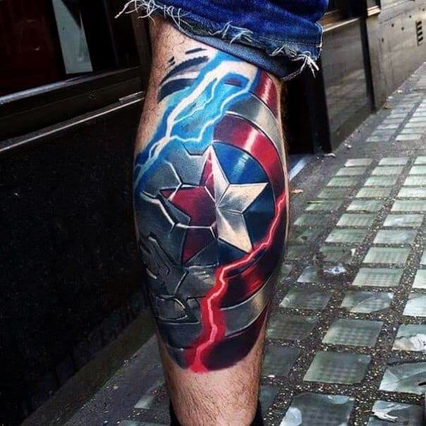 Vibrant leg tattoo of a cracked Captain America shield with bold red, white, and blue lightning streaks, creating a powerful 3D battle-worn effect.