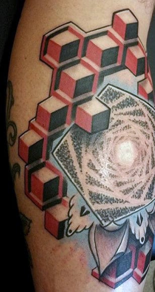 Tattoo of a 3D geometric design with red and black cubes, spiraling into a central point, overlaid with a skull