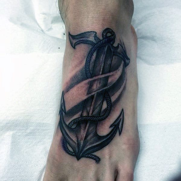 Black and gray anchor tattoo wrapped with a rope positioned on the top of a foot