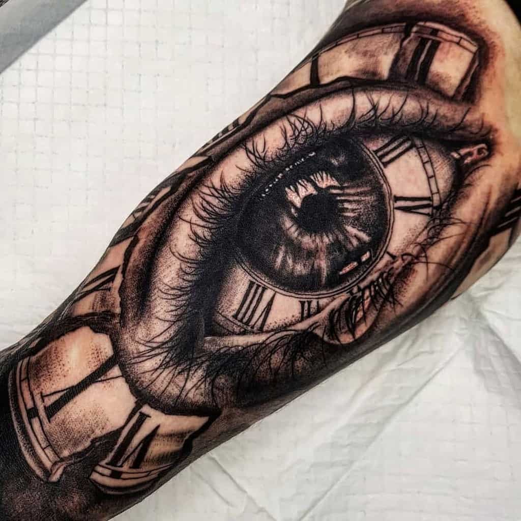Surreal tattoo of an eye with clock elements merged into the design on an arm
