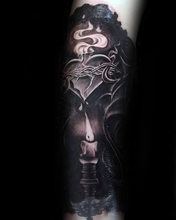 Realistic black and gray tattoo of a sacred heart wrapped in thorns, dripping tears above a burning candle