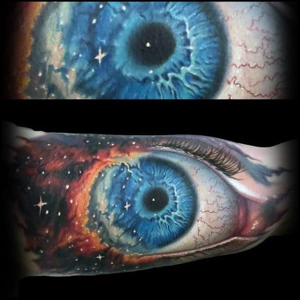 Tattoo of a blue eye surrounded by vibrant nebula patterns and stars