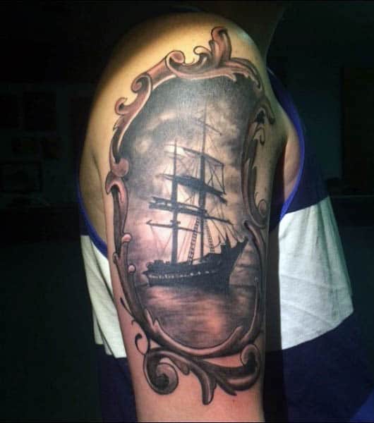 Realistic Framed Sailboat Tattoo On Mans Upper Arm