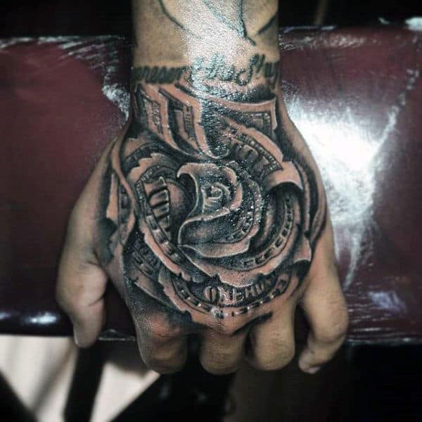 Hand with detailed black rose tattoo wrapped around a dollar bill motif