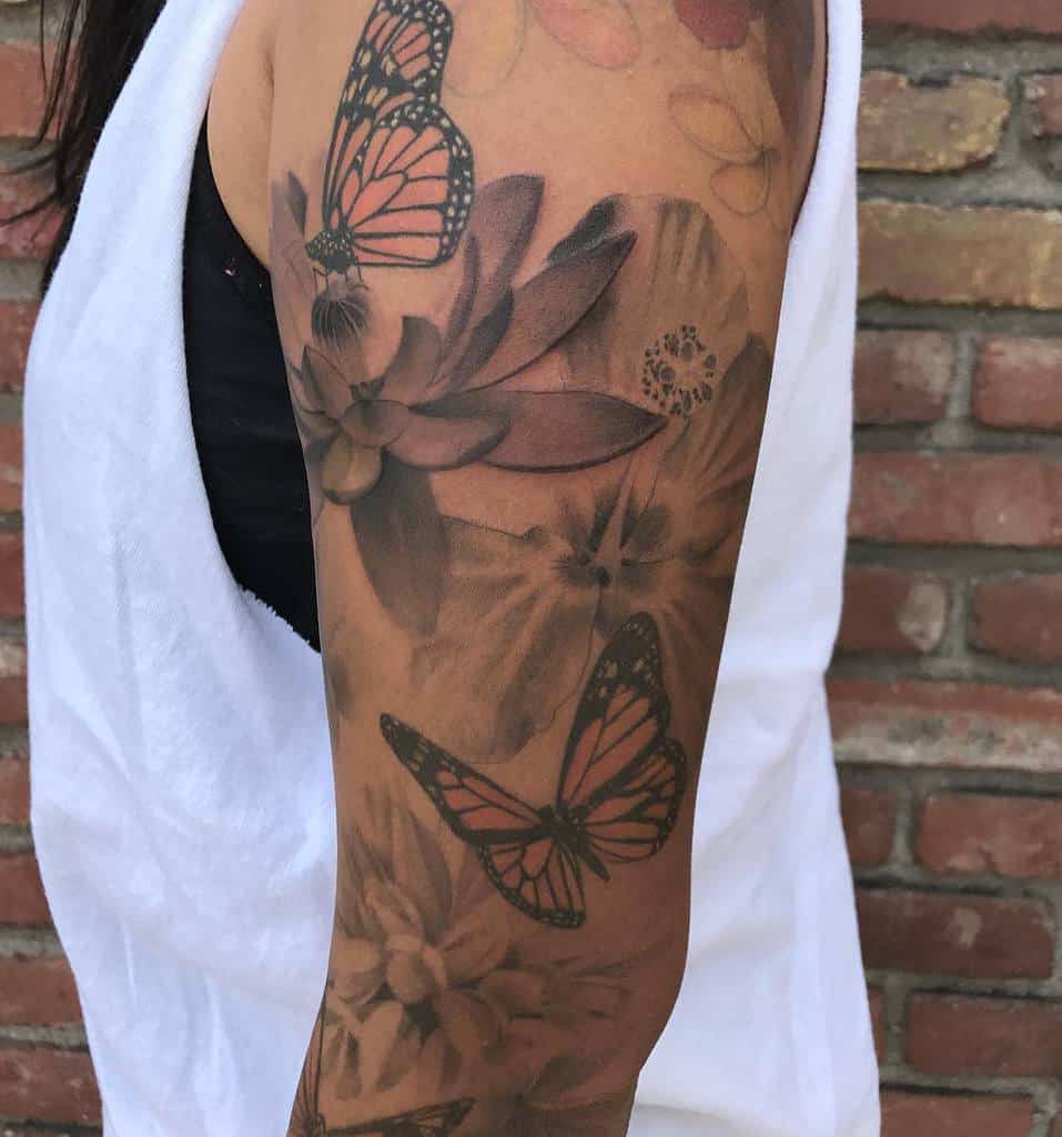 Arm tattoo featuring butterflies and flowers