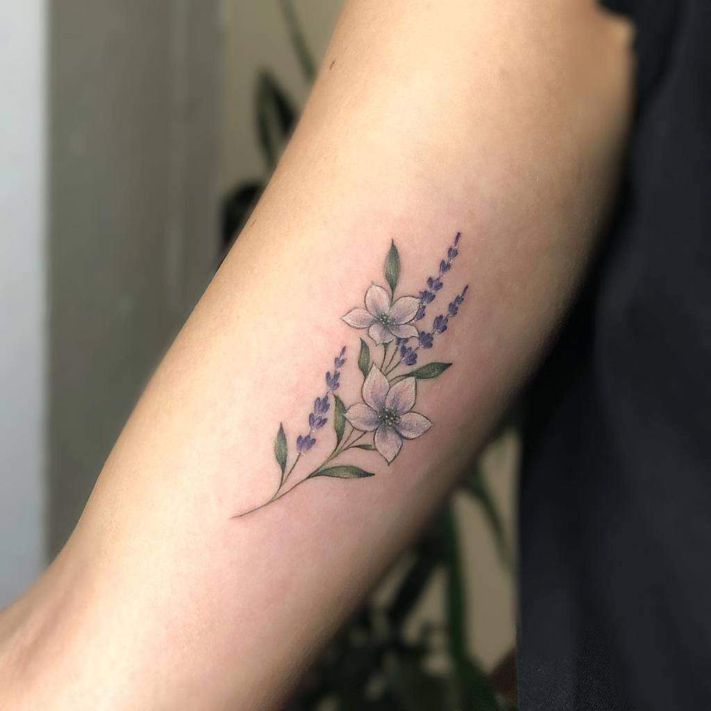 Tattoo of Jasmine flowers and leaves on a forearm