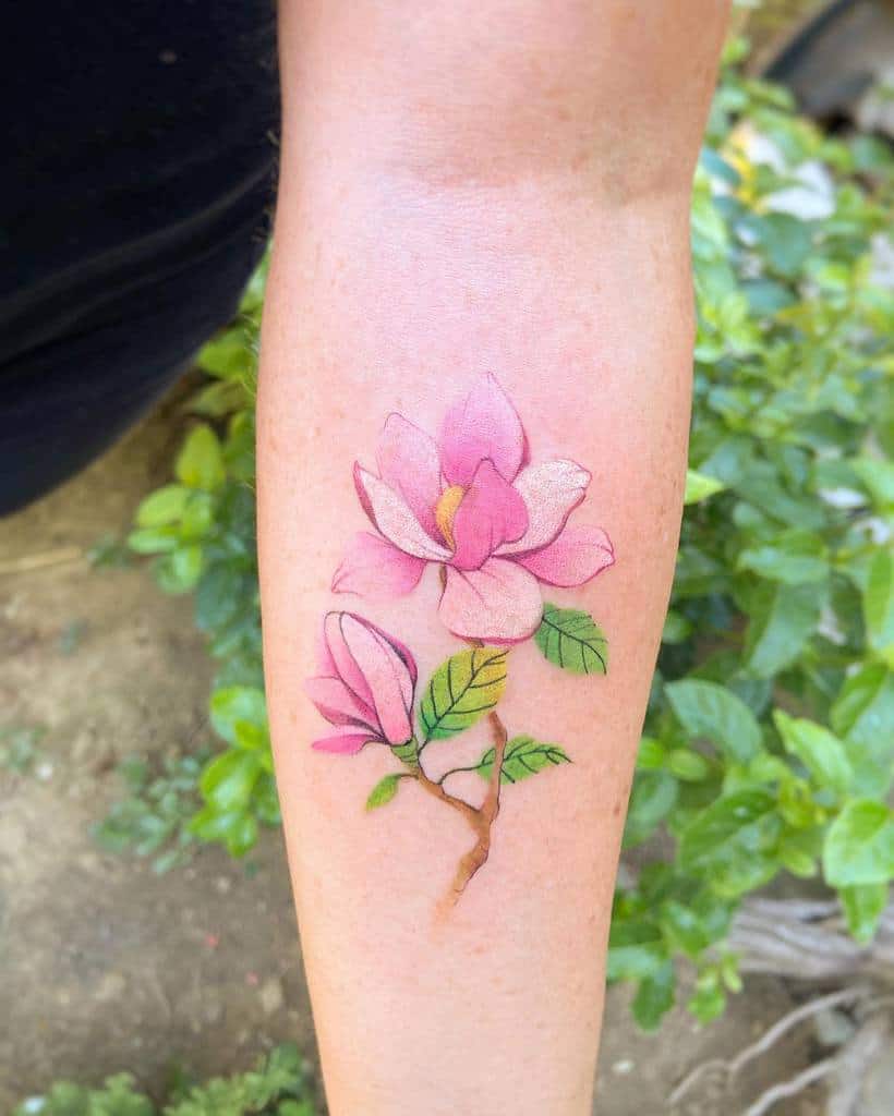 A stunning tattoo of vibrant pink magnolia flowers on the forearm