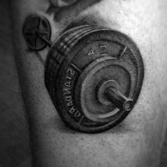 Realistic black and gray barbell tattoo with detailed shading, symbolizing strength, dedication, and passion for weightlifting and fitness.