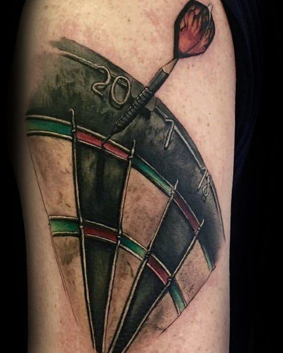 Realistic upper arm tattoo of a dartboard section with a dart hitting the triple 20, showcasing bold colors and dynamic shading.