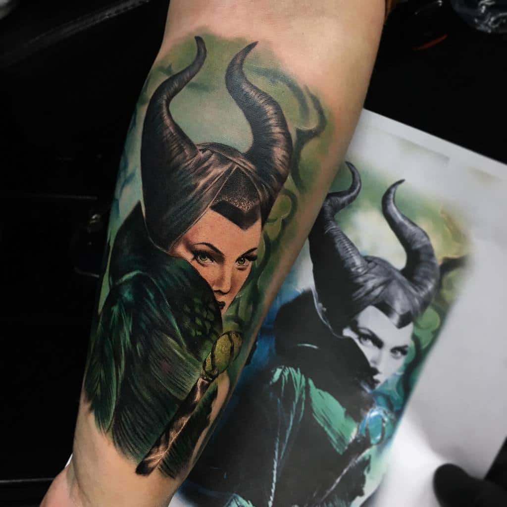 Stunningly realistic Maleficent tattoo with intricate shading and vibrant green hues, capturing her powerful and mysterious essence