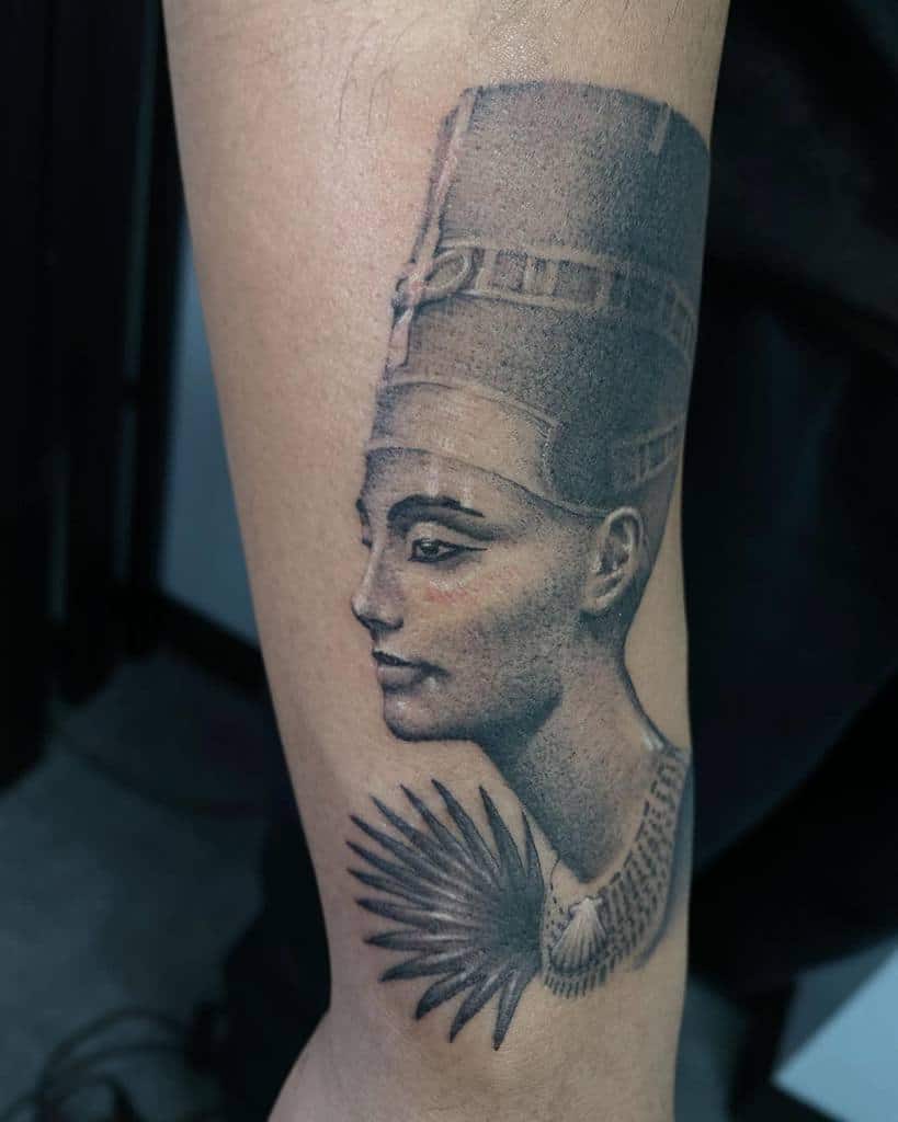 Tattoo of Nefertiti, the ancient Egyptian queen with a tall headdress, on an arm