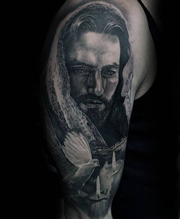 Arm tattoo of a bearded man with a hood and two doves near lit candles