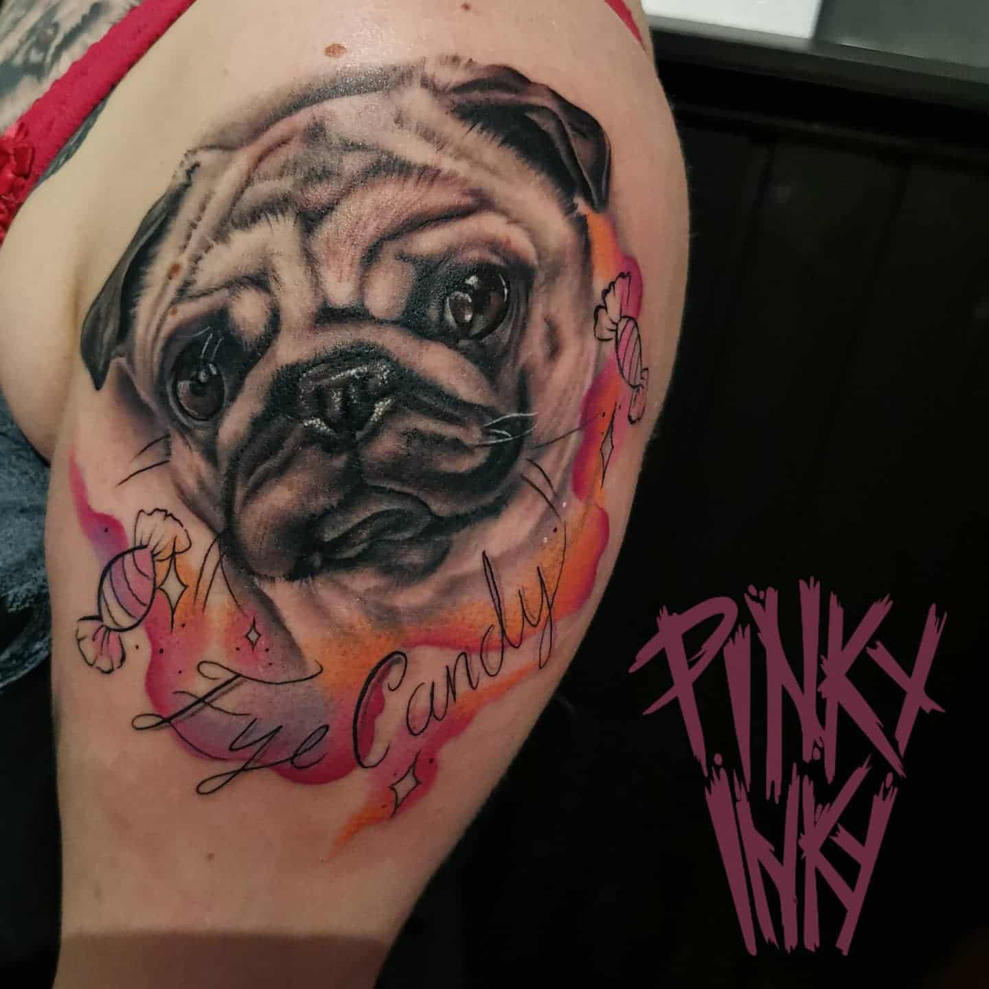 Tattoo of a pug's face on an arm, surrounded by colorful splashes and candies with stars, text reads "Eye Candy"