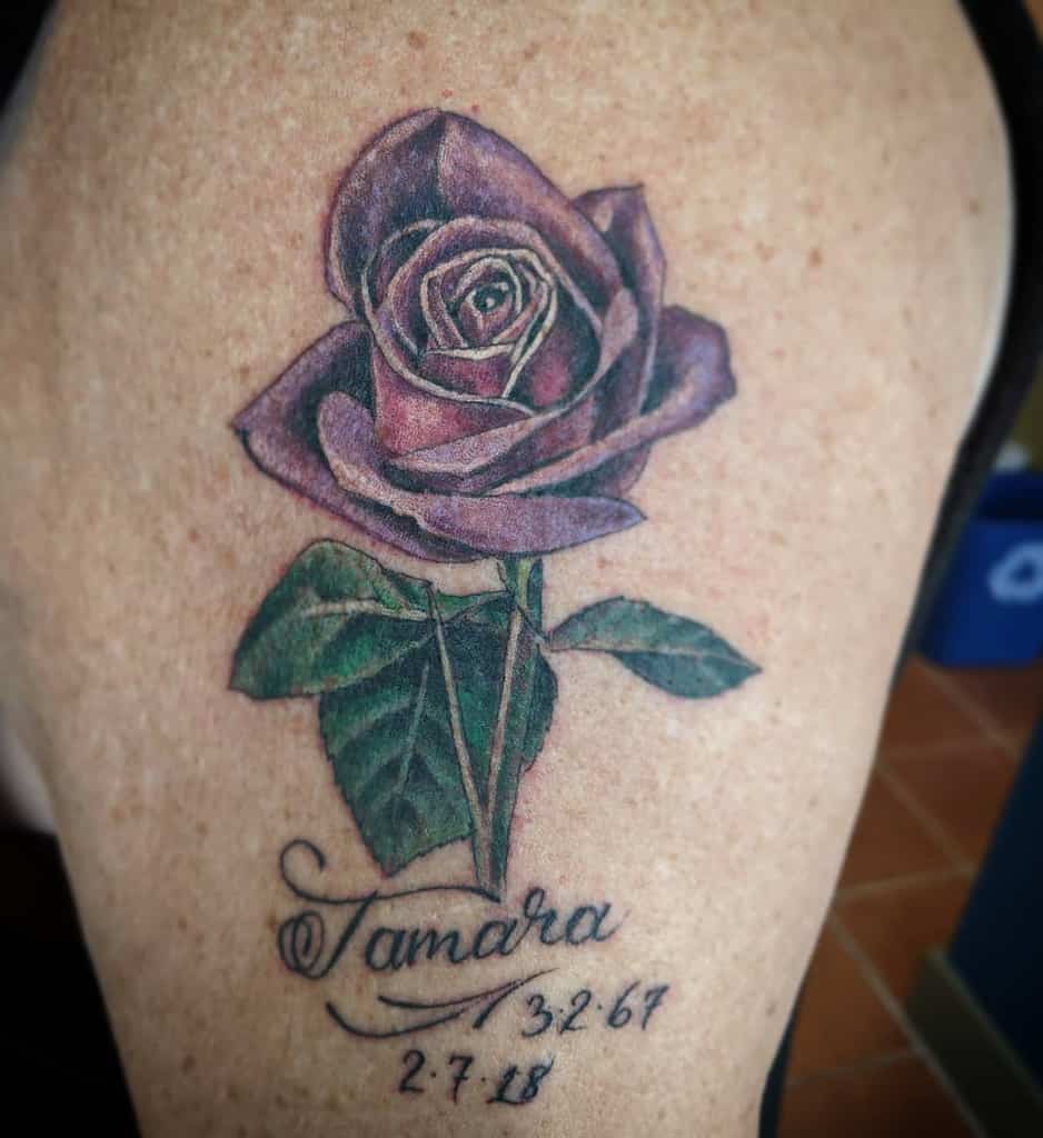 A purple rose tattoo with "Tamara" and two dates below
