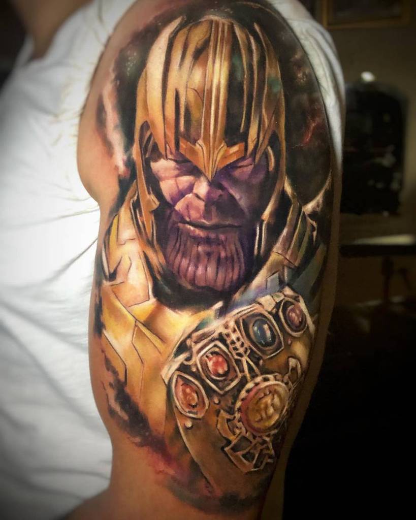 A vibrant tattoo of Thanos with his helmet in gold and purple, holding the Infinity Gauntlet, set against a colorful cosmic background