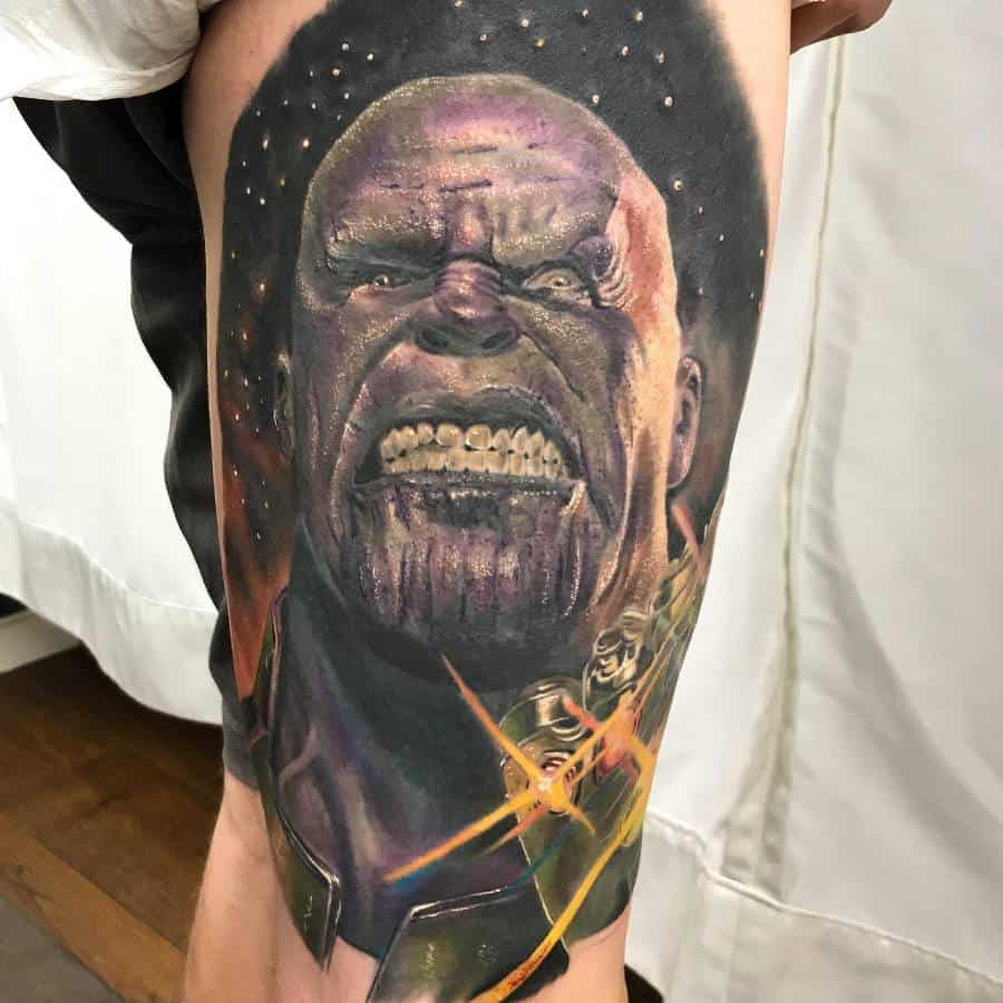 A vibrant tattoo of Thanos with a fierce expression, glowing details around his face and Infinity Gauntlet, set against a cosmic background