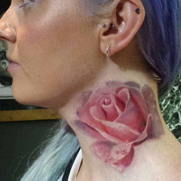 Woman with a pink rose tattoo on her neck
