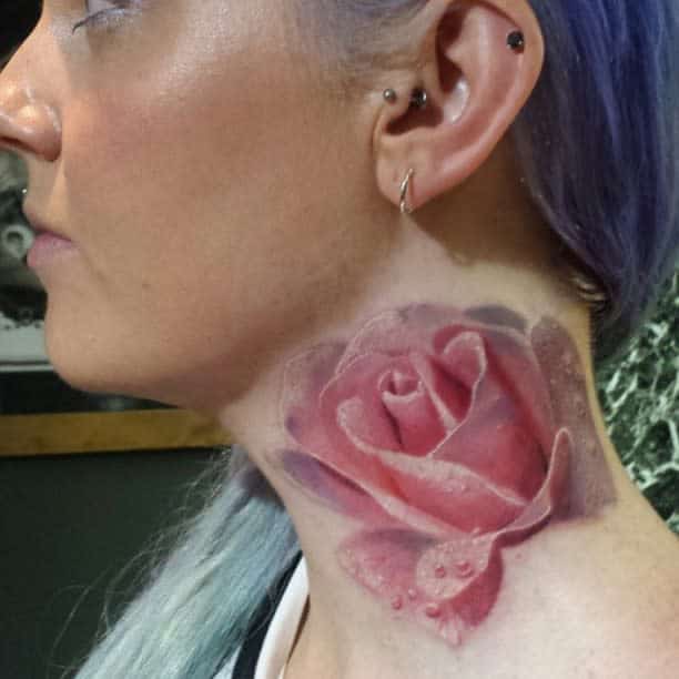 Realistic pink rose tattoo on the neck, featuring detailed petals and water droplets for a lifelike effect