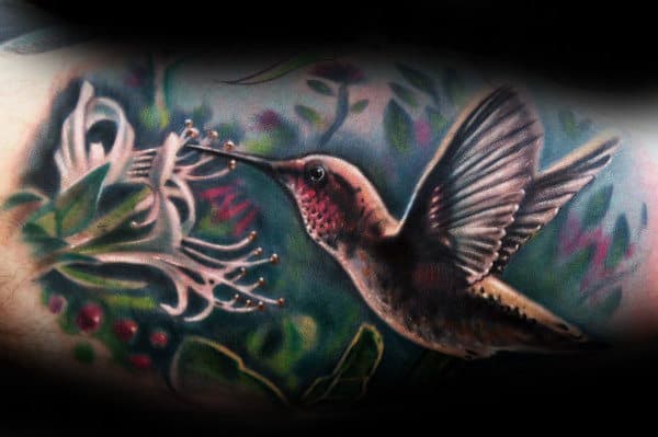 Realsitic Hummingbird With White Flower Watercolor Background Tattoo On Mans Inner Arm