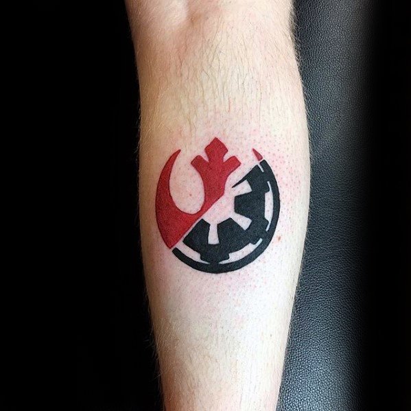 Red and black tattoo combining Rebel Alliance and Galactic Empire symbols on forearm