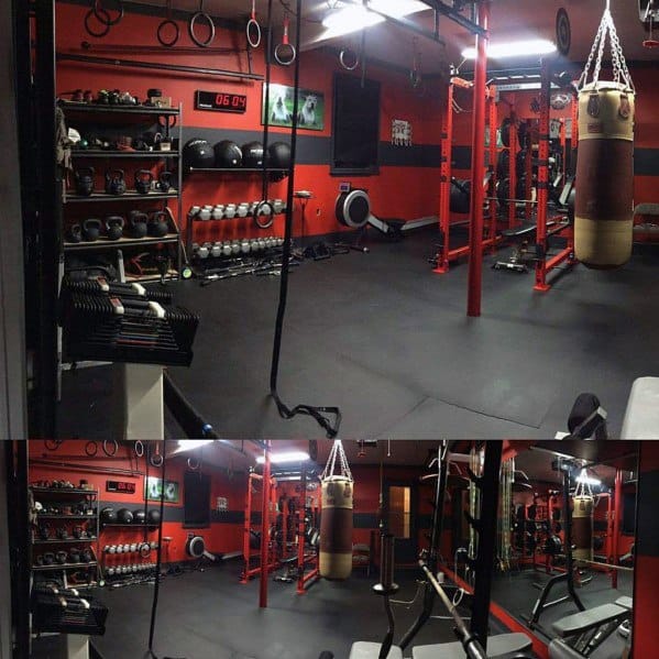 Red and black garage gym with punching bag, kettlebells, dumbbells, and functional training setup.