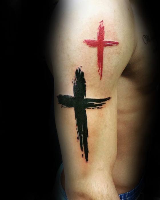 Red and black brushstroke cross tattoos on a person's upper arm