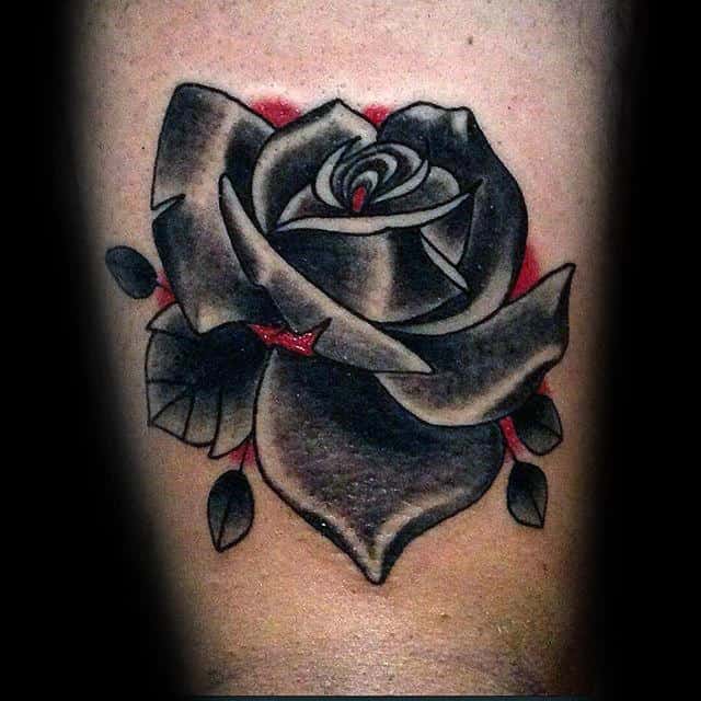 Tattoo of a black and grey rose with red accents