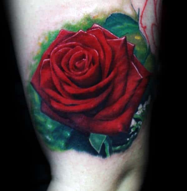 Tattoo of a vibrant red rose with green leaves